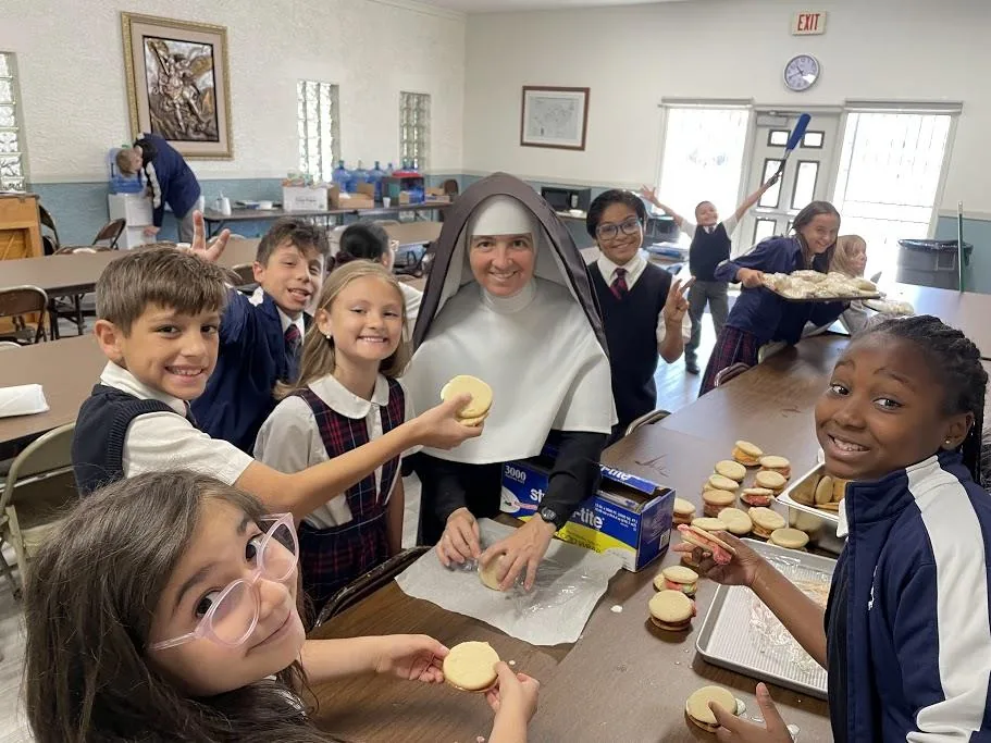 A Sister working with schoolchildren.