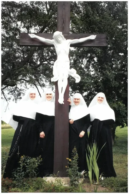 Novices gathered near the convent crucifix.