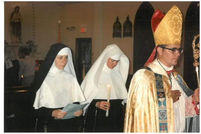 Sisters with the bishop during a religious ceremony.